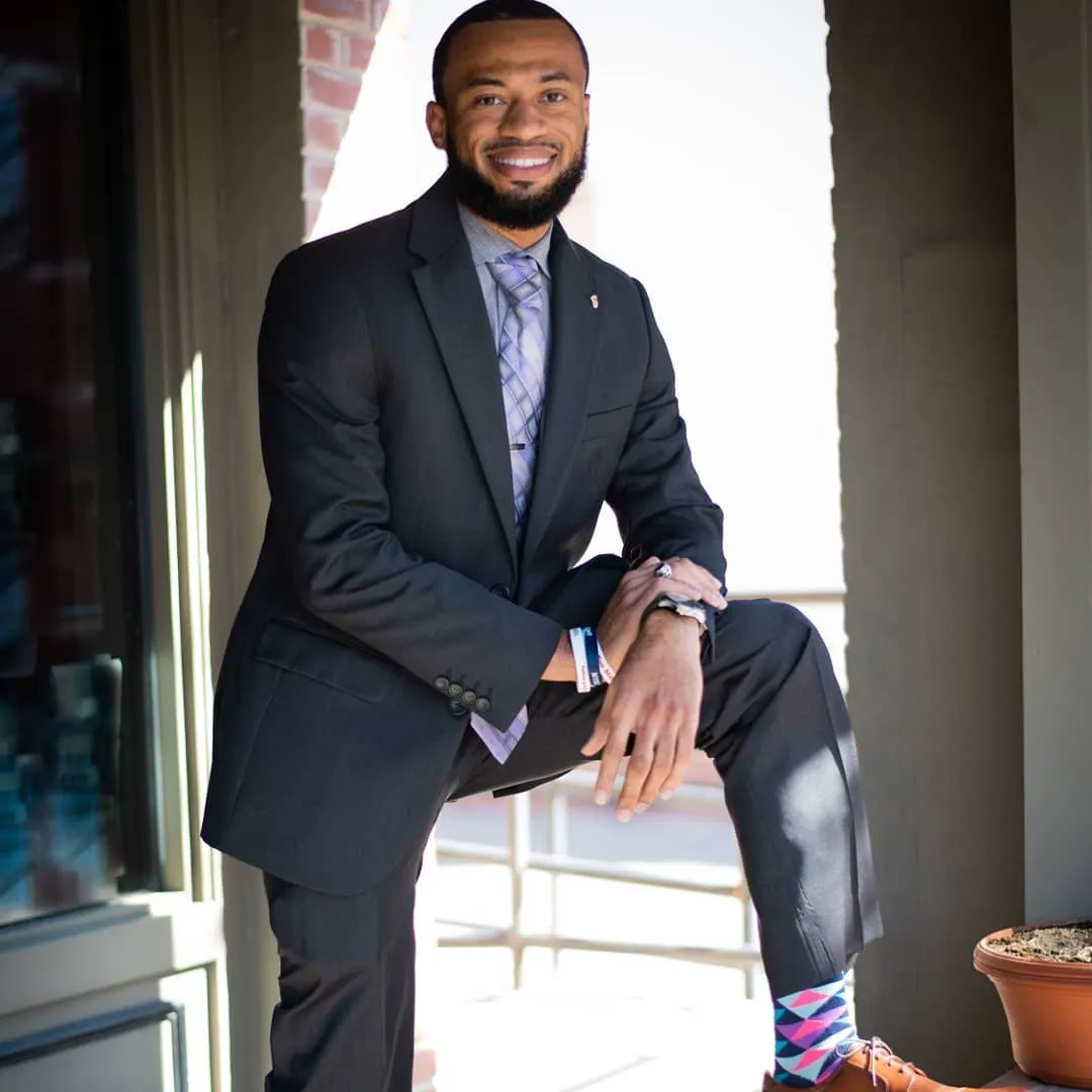 Keritan Shelby in professional business attire on a porch